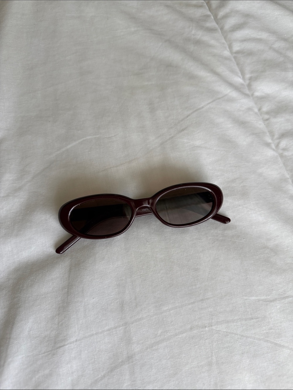 dark plum, almond shaped sunglasses